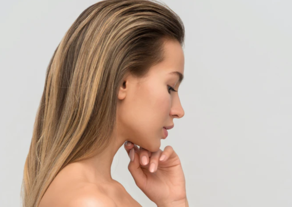 Beauty portrait of a young woman with clear skin looking down