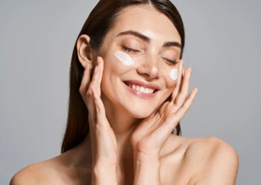 A radiant woman with cream on her face, emphasizing the benefits of aftercare for glowing skin post-microneedling.