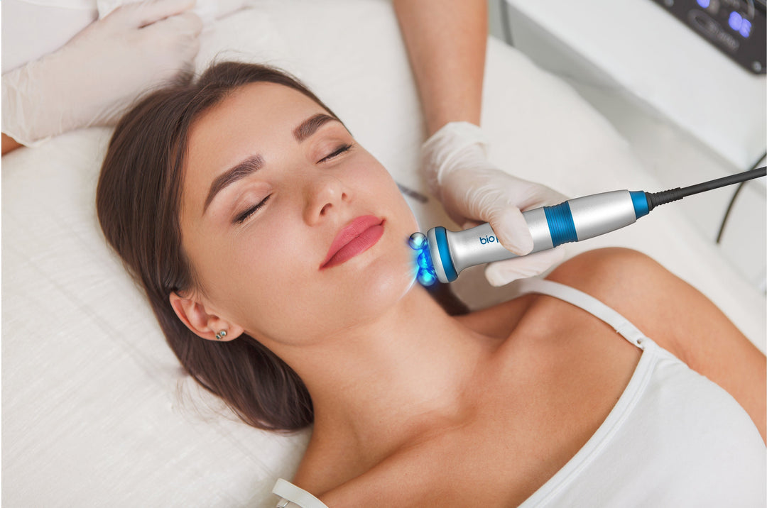 Woman enjoying her skin treatment with (RF) radiofrequency skin tightening device