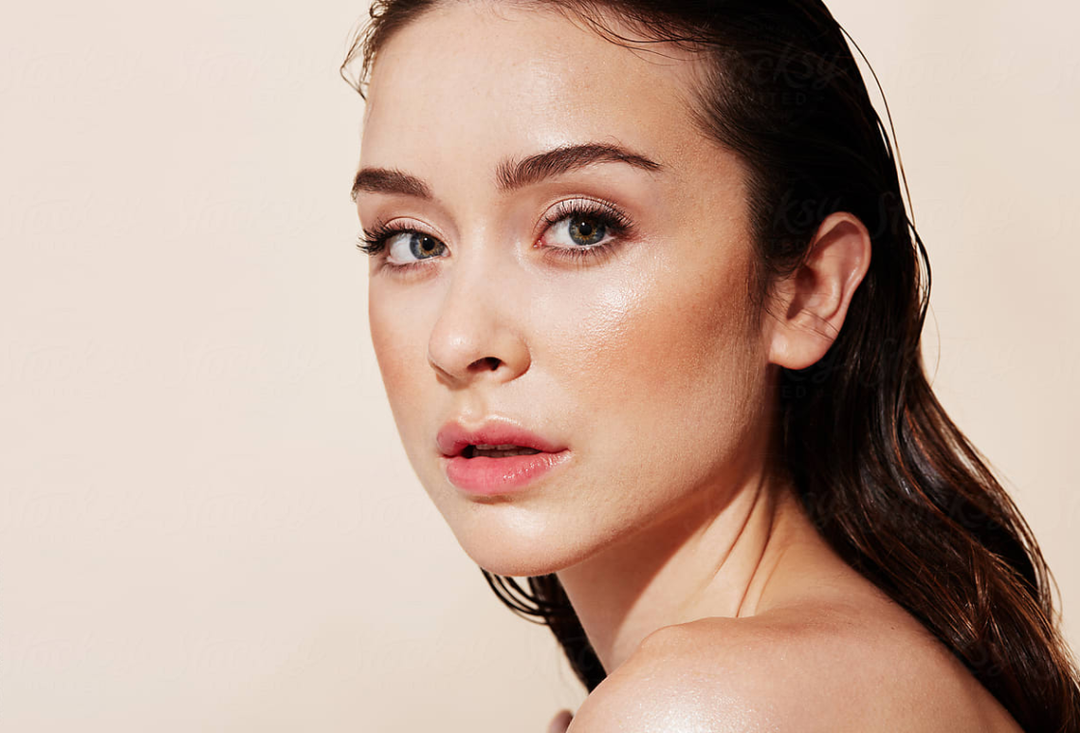 beauty shot of a woman with natural skin looking into the camera