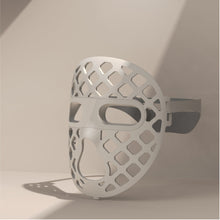 Load image into Gallery viewer, A white mesh-designed mask, the Peachaboo Glo Aurora, featuring LED light therapy technology for skin rejuvenation.