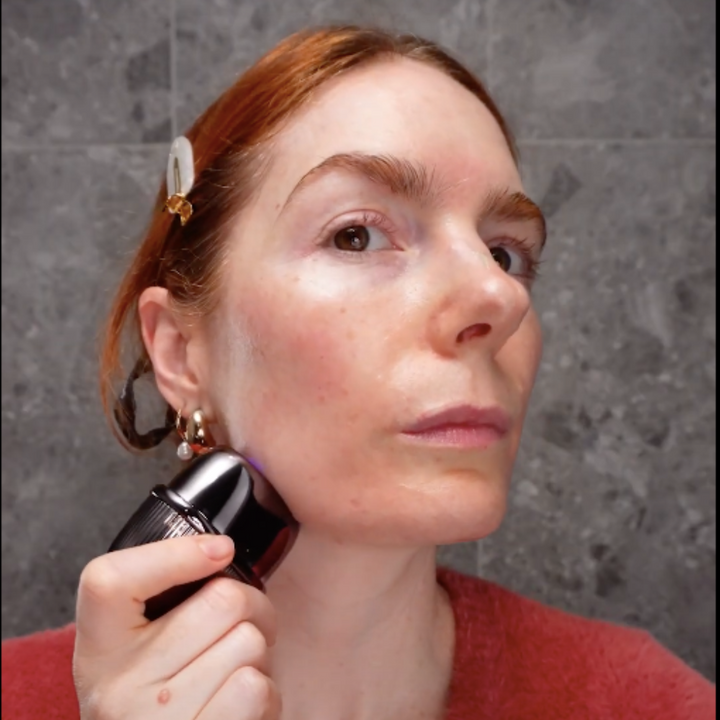  A woman holds a small black and white polka dot device, identified as the RF Matrix Max Skin Tightening Device (Grey Version).