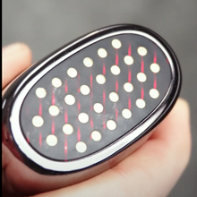 Load image into Gallery viewer,  A person presents a grey RF Matrix Max Skin Tightening Device, featuring a distinctive black and red polka dot design.