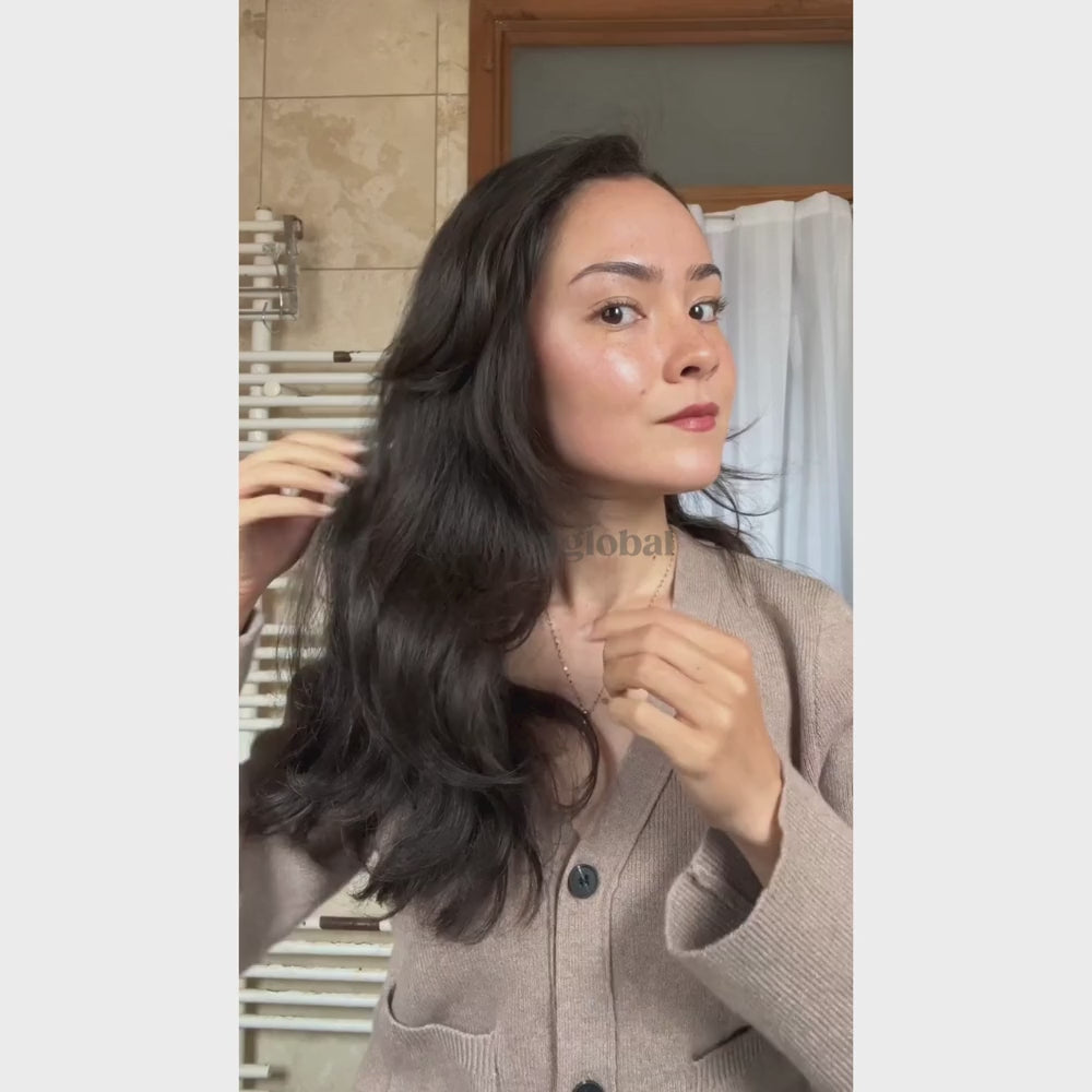 A woman using Reboot Scalp Rejuvenator LED Comb 