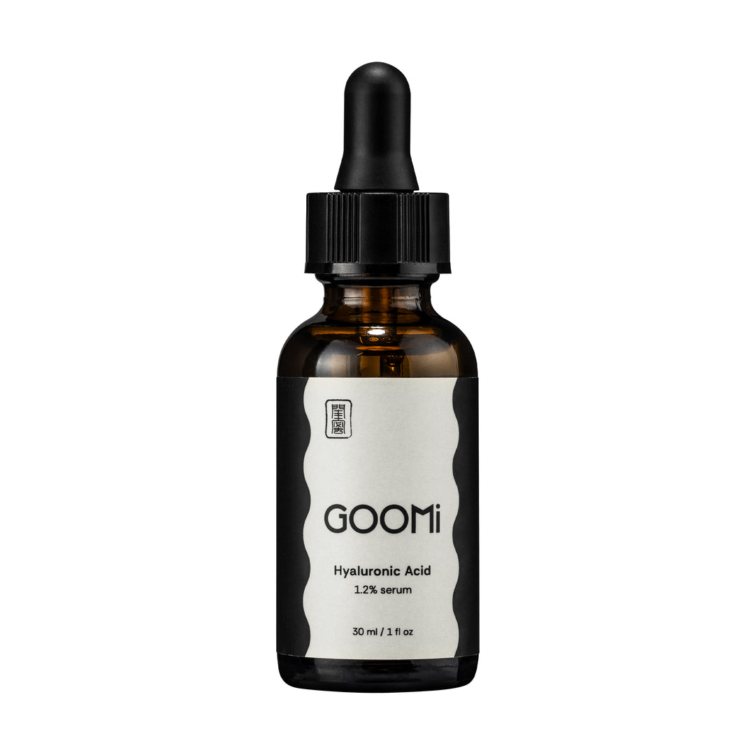 A 30 ml amber glass dropper bottle of GOOMi Hyaluronic Acid 1.2% serum, featuring a black dropper cap and a white label with black text.