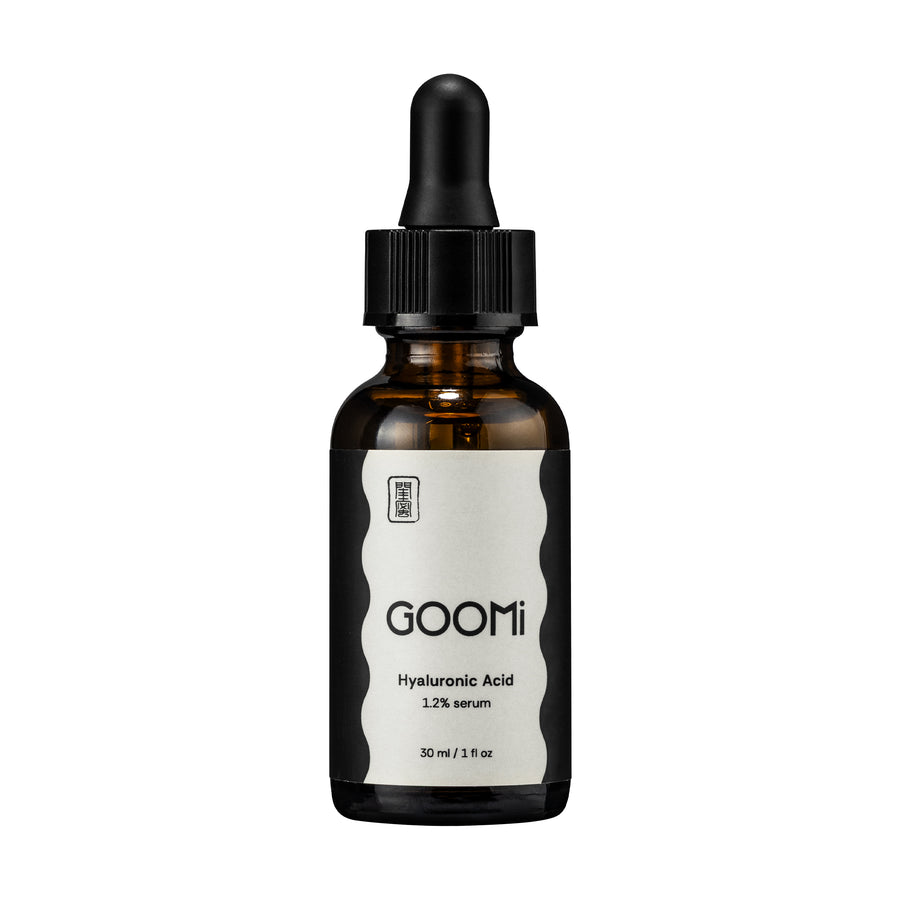 A 30 ml amber glass dropper bottle of GOOMi Hyaluronic Acid 1.2% serum, featuring a black dropper cap and a white label with black text.