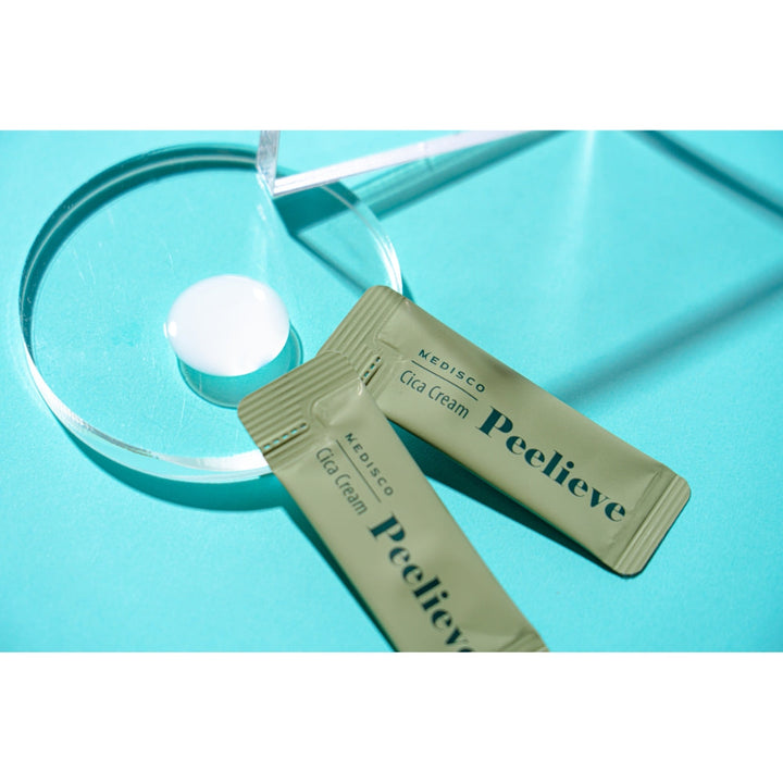 Medisco Peelieve Cica Cream pouches with cream texture on glass dish against a bright blue background